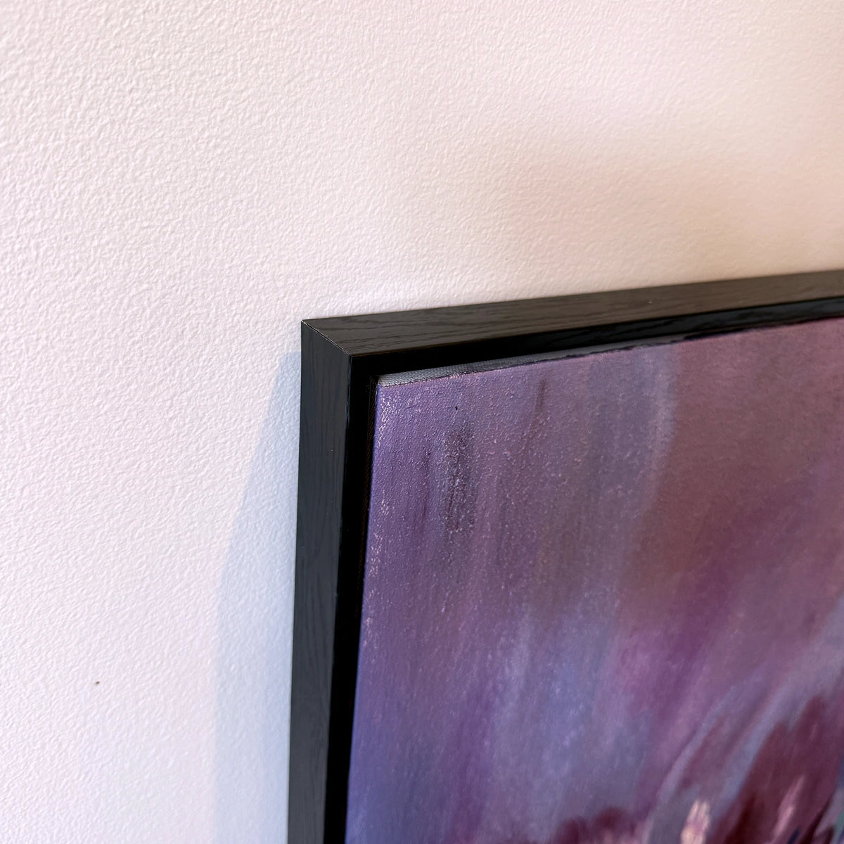 Corner detail of Violet Layers black wood frame and canvas edge