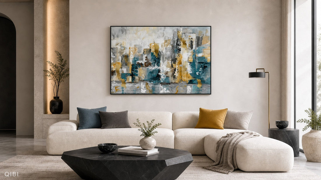 Abstract blue grey and yellow wall art in a modern living room with a cream sofa and geometric black coffee table